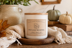 Olive Tree Marketplace Snuggle Weather candle in a cozy autumn setting