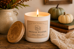 Olive Tree Marketplace Snuggle Weather candle lit in a cozy autumn setting